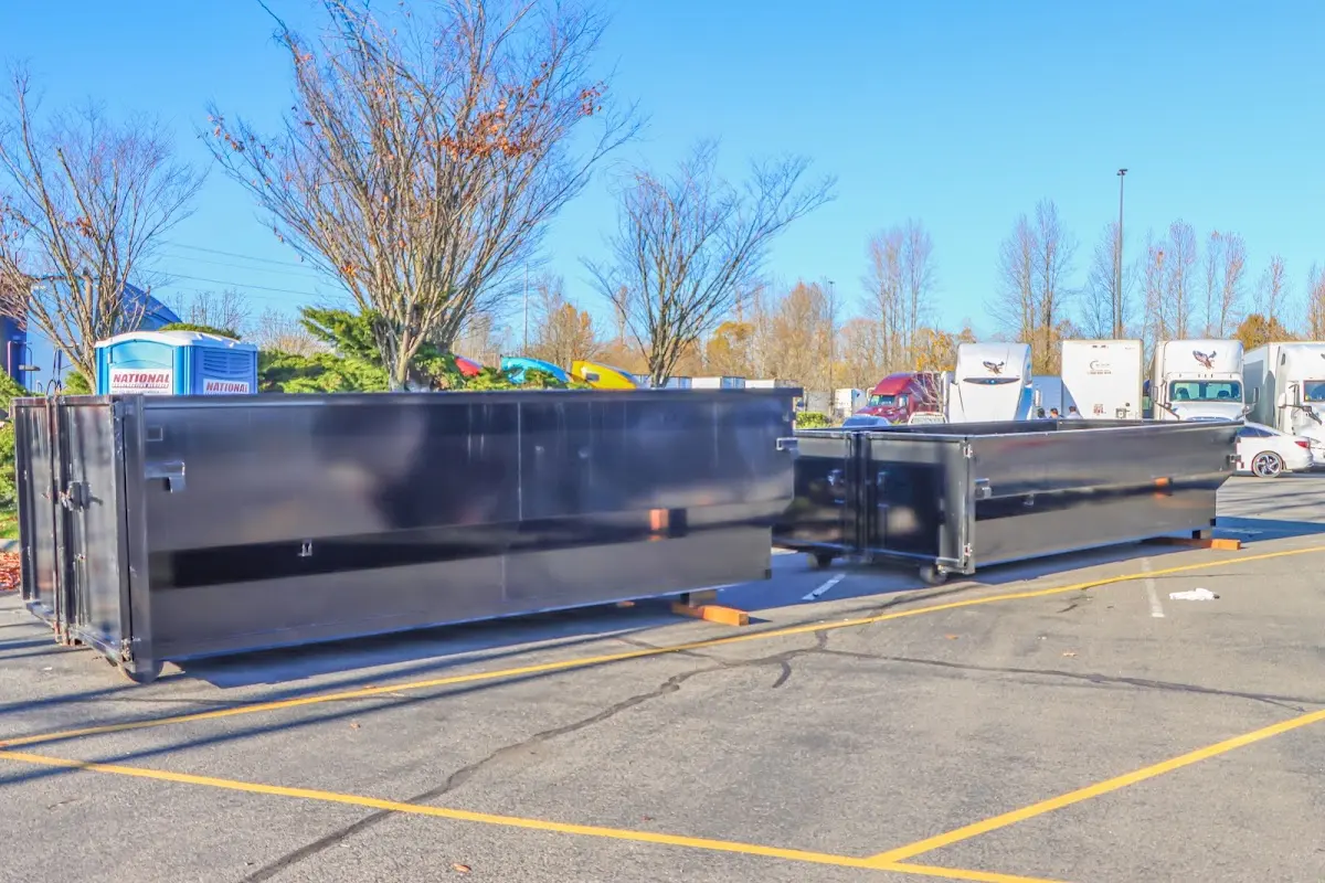 Professional dumpster rental service with roll-off container on residential driveway in Fort Mitchell